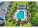 Aerial view of a community pool with ample seating, surrounded by well-maintained landscaping and charming townhomes at 101 Culpepper Way # 1006, Myrtle Beach, SC 29579