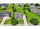 Aerial view of a well-maintained, light blue two-story home with a brick facade and a meticulously manicured lawn at 1025 Limpkin Dr., Conway, SC 29526