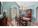 Bright dining room with vaulted ceiling, arched window, and traditional furnishings at 1025 Limpkin Dr., Conway, SC 29526