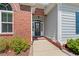 Close-up view of a home's front door with brick accents and a welcoming entrance at 1025 Limpkin Dr., Conway, SC 29526