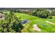 Picturesque golf course with a sand trap, pond, and lush greenery, offering a scenic view for golf enthusiasts at 1025 Limpkin Dr., Conway, SC 29526