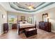 Inviting main bedroom features a tray ceiling, four-poster bed, and ample natural light at 1025 Limpkin Dr., Conway, SC 29526