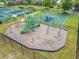 A colorful playground with swings and slides, nestled within a fenced area surrounded by green spaces at 1025 Limpkin Dr., Conway, SC 29526