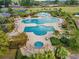 Aerial view of an elaborate swimming pool complex with multiple pools, seating areas, and lush landscaping at 1025 Limpkin Dr., Conway, SC 29526