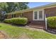 Back exterior showcasing the brickwork, French doors and well maintained landscaping at 1043 South Main St., Aynor, SC 29511