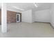 Spacious basement with painted concrete floor, brick accent wall, and plenty of lighting at 1043 South Main St., Aynor, SC 29511