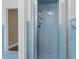 Bright blue retro tiled bathroom with shower, glass door, and adjacent toilet at 1043 South Main St., Aynor, SC 29511