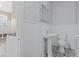Stylish bathroom with a pedestal sink, elegant mirror, and modern fixtures at 1043 South Main St., Aynor, SC 29511