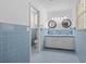 Clean bathroom with double sinks and white countertops, accented by blue retro tile at 1043 South Main St., Aynor, SC 29511