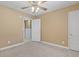 Comfortable bedroom featuring a ceiling fan and access to an adjoining room at 1043 South Main St., Aynor, SC 29511