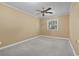 Cozy bedroom featuring neutral walls, plush gray carpeting, and a ceiling fan for added comfort at 1043 South Main St., Aynor, SC 29511