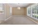 Light-filled dining room featuring neutral walls, large windows, and a modern light fixture at 1043 South Main St., Aynor, SC 29511