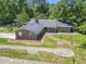 Aerial view of the brick home, showcasing the beautiful brickwork and metal roof at 1043 South Main St., Aynor, SC 29511