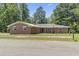 Charming brick ranch home with a metal roof and well-maintained front yard at 1043 South Main St., Aynor, SC 29511