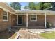 Inviting brick home entrance with a covered porch and a charming brick walkway at 1043 South Main St., Aynor, SC 29511