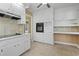 Traditional kitchen showcasing white cabinets, tile backsplash, and modern built-in appliances at 1043 South Main St., Aynor, SC 29511