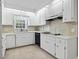 Traditional kitchen featuring bright, white cabinets, tile backsplash, and modern appliances at 1043 South Main St., Aynor, SC 29511