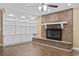 Inviting living room featuring a brick fireplace and built-in shelving, enhancing the cozy ambiance at 1043 South Main St., Aynor, SC 29511
