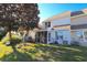 Backyard featuring a screened porch, lush lawn, and mature trees, providing a private and peaceful outdoor setting at 107 Pawleys Place Dr. # 107, Pawleys Island, SC 29585