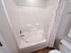 All-white bathroom with tub-shower combo and neutral shower curtain at 107 Pawleys Place Dr. # 107, Pawleys Island, SC 29585