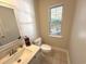 Half bathroom with tile flooring, stylish mirror, and granite counter at 107 Pawleys Place Dr. # 107, Pawleys Island, SC 29585