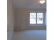 Cozy bedroom with neutral walls and carpet, featuring a ceiling fan and window at 107 Pawleys Place Dr. # 107, Pawleys Island, SC 29585