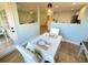 Open dining room with a set table and light hardwood floors at 107 Pawleys Place Dr. # 107, Pawleys Island, SC 29585
