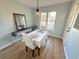 Bright dining room featuring a window view and a table with seating for two at 107 Pawleys Place Dr. # 107, Pawleys Island, SC 29585