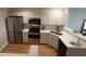 Well-lit kitchen featuring stainless steel appliances, new countertops, and white cabinets at 107 Pawleys Place Dr. # 107, Pawleys Island, SC 29585