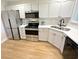 Bright kitchen with stainless steel appliances, white cabinets, and hardwood floors at 107 Pawleys Place Dr. # 107, Pawleys Island, SC 29585