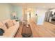Spacious living room with hardwood floors, stylish furniture, and an open staircase at 107 Pawleys Place Dr. # 107, Pawleys Island, SC 29585