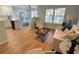 Comfortable living room with hardwood floors, couch, and bright natural light at 107 Pawleys Place Dr. # 107, Pawleys Island, SC 29585
