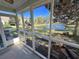 View from screened porch featuring a scenic pond view and lush greenery, creating a serene outdoor living space at 107 Pawleys Place Dr. # 107, Pawleys Island, SC 29585