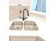 Close-up view of a stainless steel double sink and quartz countertops in an updated kitchen at 107 Pawleys Place Dr. # 107, Pawleys Island, SC 29585