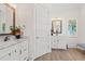 Elegant bathroom with double vanities, marble countertops, modern fixtures, decorative mirrors and wall art at 109 Serenity Point Dr., Little River, SC 29566