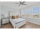 Cozy bedroom featuring a ceiling fan, plantation shutters, and a view of the community at 109 Serenity Point Dr., Little River, SC 29566
