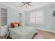 Bedroom with built in bookcases above the bed, a large window, and modern ceiling fan at 109 Serenity Point Dr., Little River, SC 29566