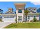 Beautiful beach home featuring a manicured lawn, garage, decorative palms and a charming front entryway at 109 Serenity Point Dr., Little River, SC 29566