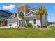Inviting home exterior features a well-manicured lawn, landscaping, and several palm trees in the front yard at 109 Serenity Point Dr., Little River, SC 29566