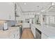 Gourmet kitchen features white cabinets, stainless appliances, a marble island, and mosaic tile backsplash at 109 Serenity Point Dr., Little River, SC 29566