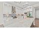 Modern kitchen features white cabinetry, mosaic backsplash, stainless steel appliances, and a marble center island at 109 Serenity Point Dr., Little River, SC 29566