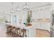 Stylish kitchen boasts white cabinetry, marble countertops, a central island, and modern lighting at 109 Serenity Point Dr., Little River, SC 29566