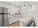 Charming kitchenette featuring white cabinets, marble countertops, and stainless steel appliances at 109 Serenity Point Dr., Little River, SC 29566