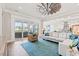Bright living room features a patio view, stylish seating, and an open-concept layout into the kitchen at 109 Serenity Point Dr., Little River, SC 29566