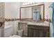 Bathroom with seashell wallpaper border, wooden-framed mirror, and updated vanity at 1100 Possum Trot Rd. # C-203, North Myrtle Beach, SC 29582
