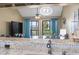 Open dining area with modern lighting, views to the outdoors, and access to the balcony at 1100 Possum Trot Rd. # C-203, North Myrtle Beach, SC 29582
