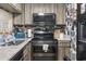 Modern kitchen with stainless steel appliances, unique backsplash, and ample counter space for meal preparation at 1100 Possum Trot Rd. # C-203, North Myrtle Beach, SC 29582
