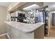 Open kitchen with granite countertops, stainless steel appliances, and unique backsplash design at 1100 Possum Trot Rd. # C-203, North Myrtle Beach, SC 29582
