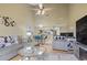 Open-concept living room with dining area features modern furniture, high ceiling and ample lighting at 1100 Possum Trot Rd. # C-203, North Myrtle Beach, SC 29582