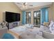 Comfortable living room featuring a fireplace, plush seating, and direct access to the outdoor balcony at 1100 Possum Trot Rd. # C-203, North Myrtle Beach, SC 29582